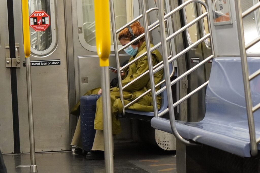 DSC01620 A girl looking at her phone inside a subway train seen in New York City in November 2021